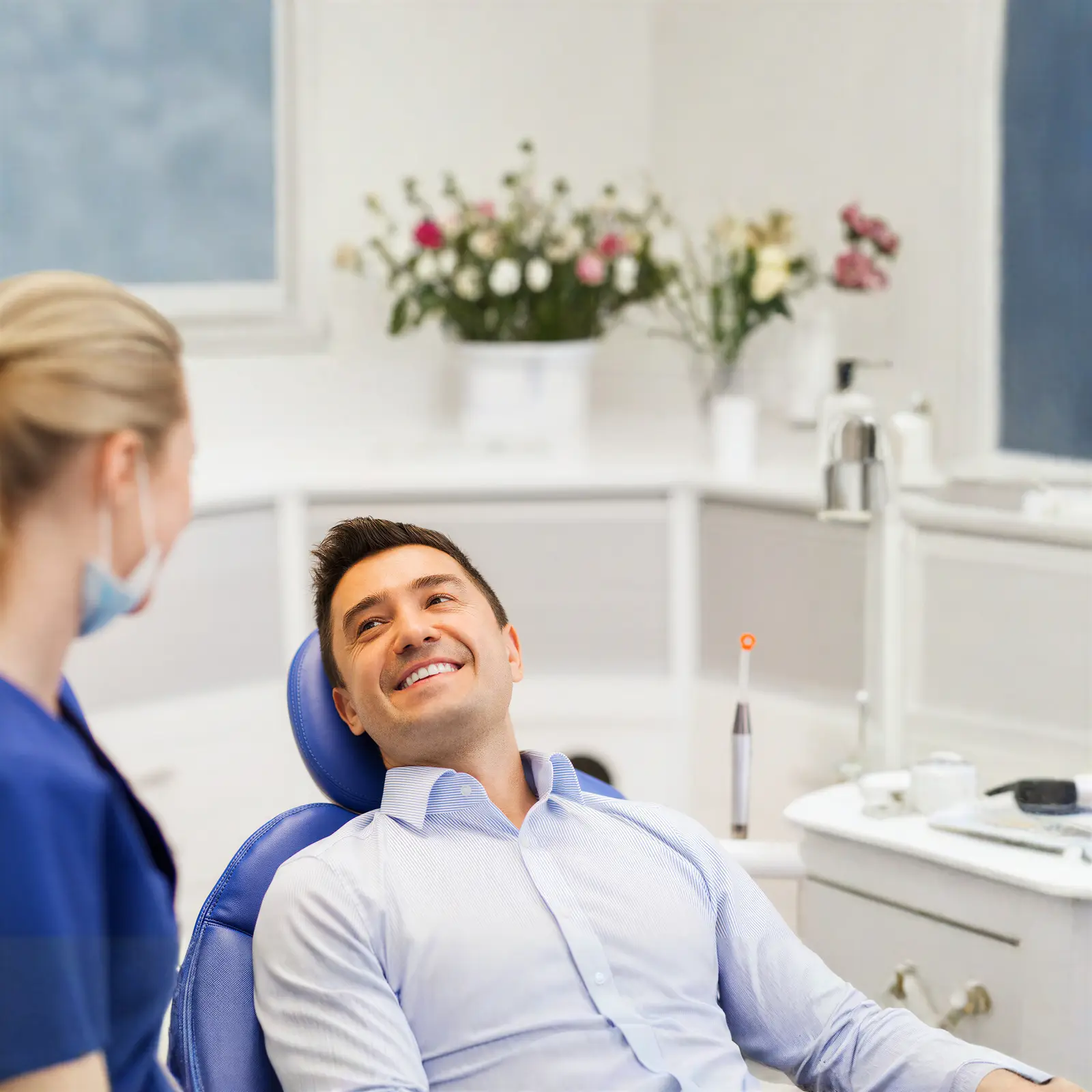 Dentist consulting with a happy patient at Sierra Springs Dental in Airdrie