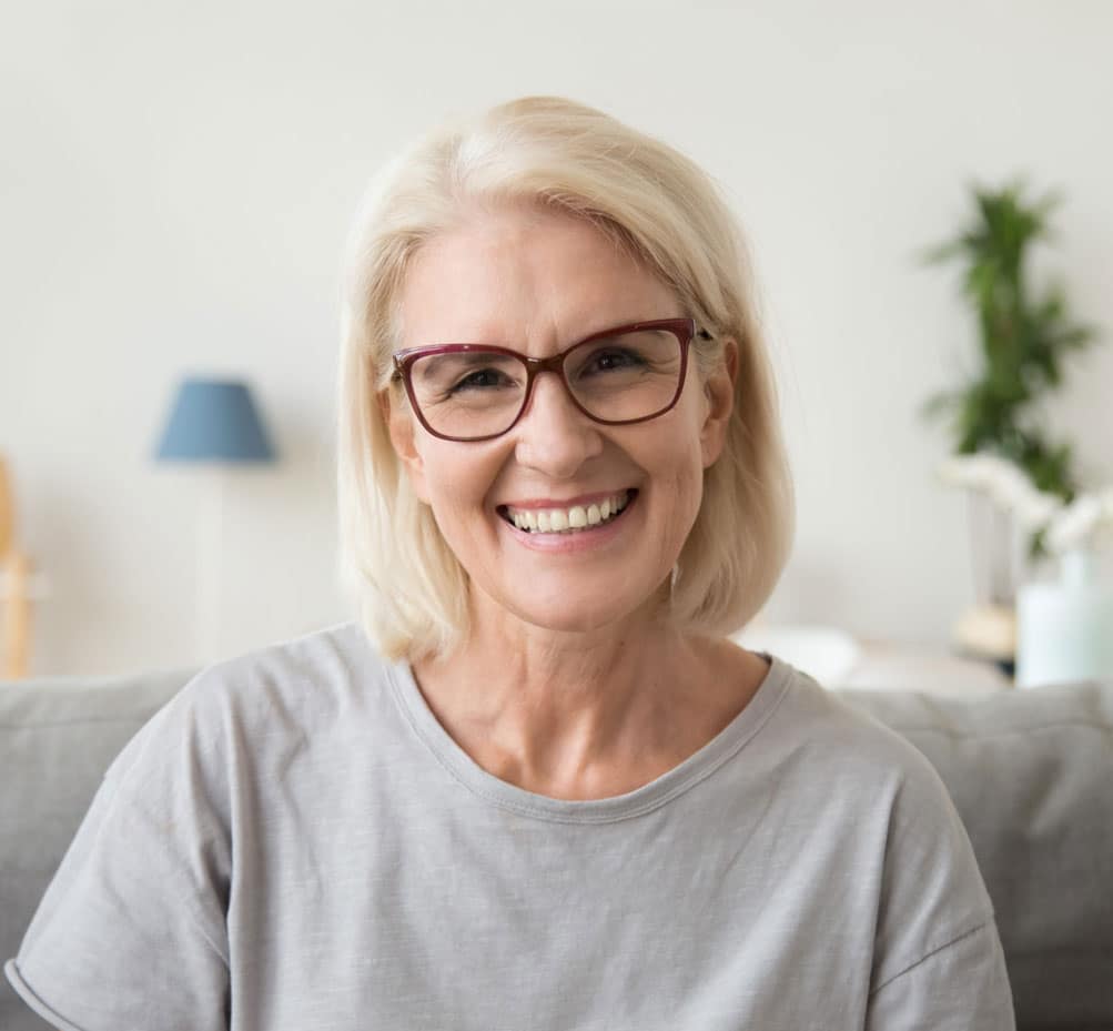 Senior patient smiling after restorative dental treatment