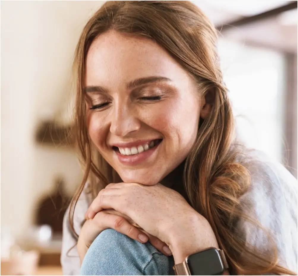 Woman with a bright, white smile after professional teeth whitening